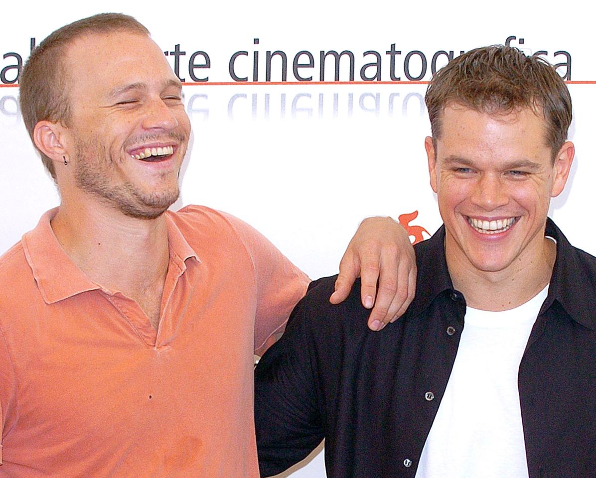 Heath Ledger and Matt Damon smiling together with one arm around the others shoulder