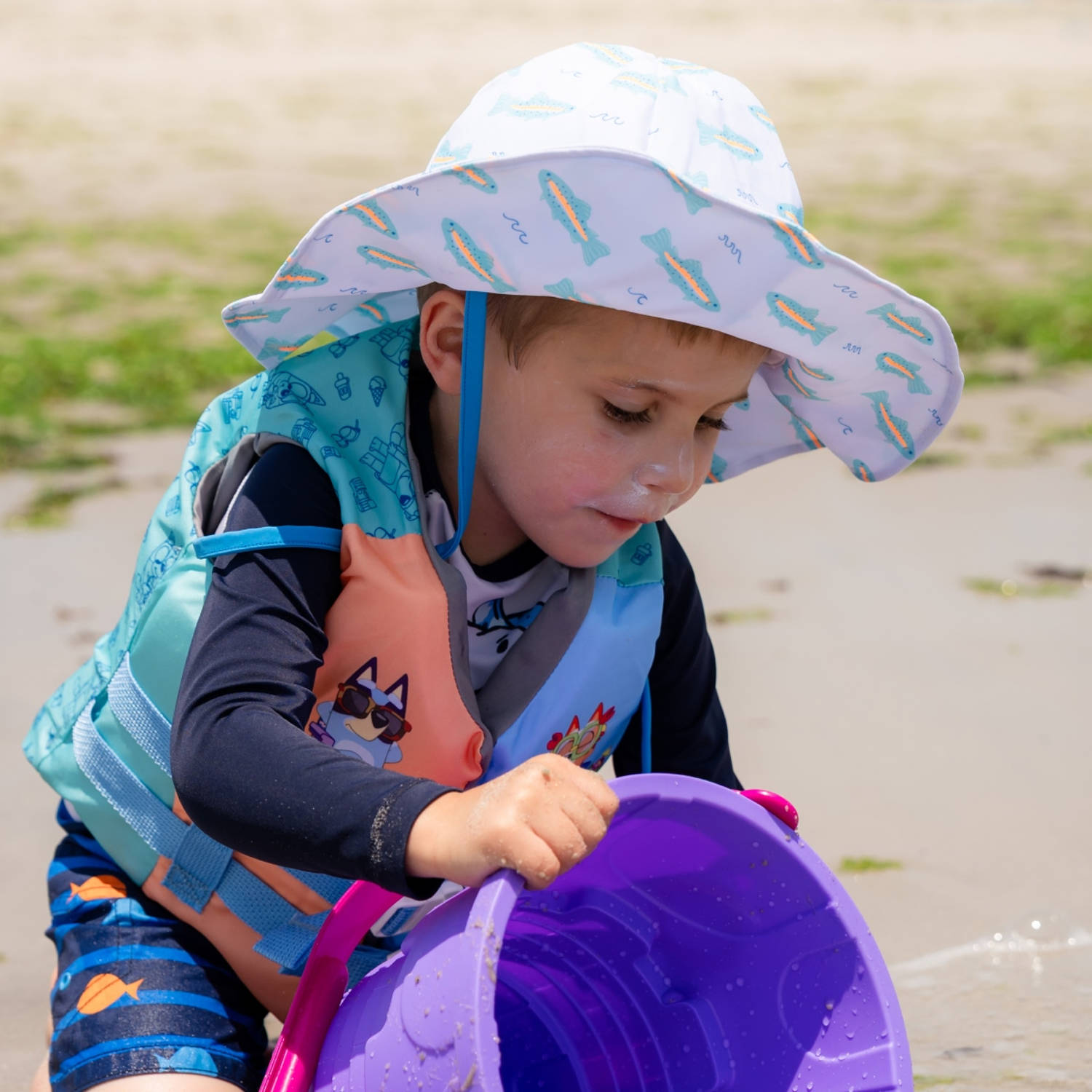 Caden Lane's sun hat kept his face out of the sun all day and didn't budge even mid sandcastle-building. (Courtesy Daniel Landesman Photography)