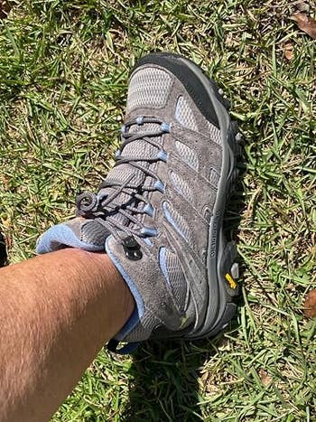 Hiking boot on grass, showcasing its rugged design and supportive features ideal for outdoor activities