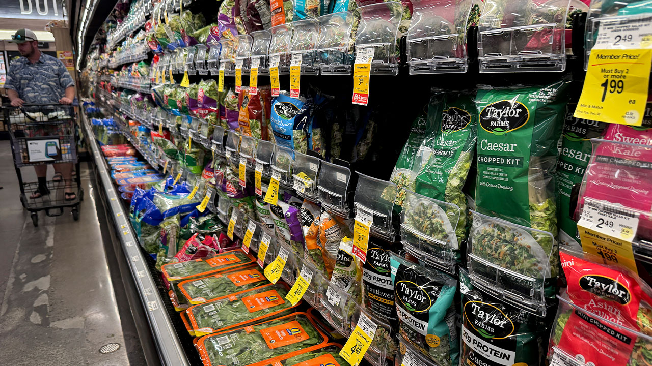 Packages of Taylor Farms salad greens displayed on shelves at a Safeway grocery store in California