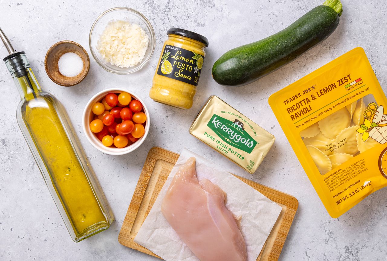 Ingredients for a quick dinner including chicken breast zucchini ricotta ravioli cherry tomatoes lemon pesto and olive oil