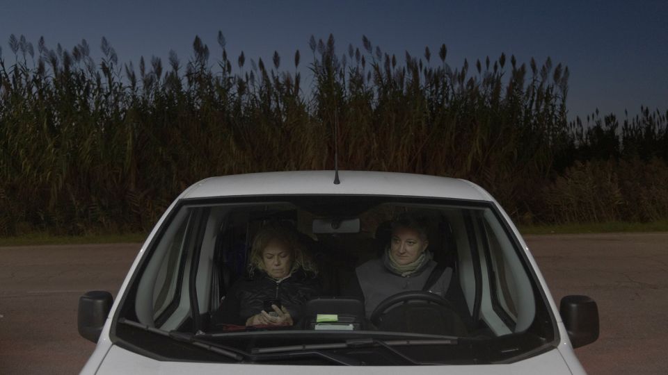Former fisherwomen Serena Farabotin and Oscarina Soncin sit in the car before going home after work. The two women met after both were forced to leave the water by the blue crab crisis. Today, they work together in a cleaning company, their new friendship shaped by a place where people have long relied on one another to face loss and uncertainty. - Chiara Negrello