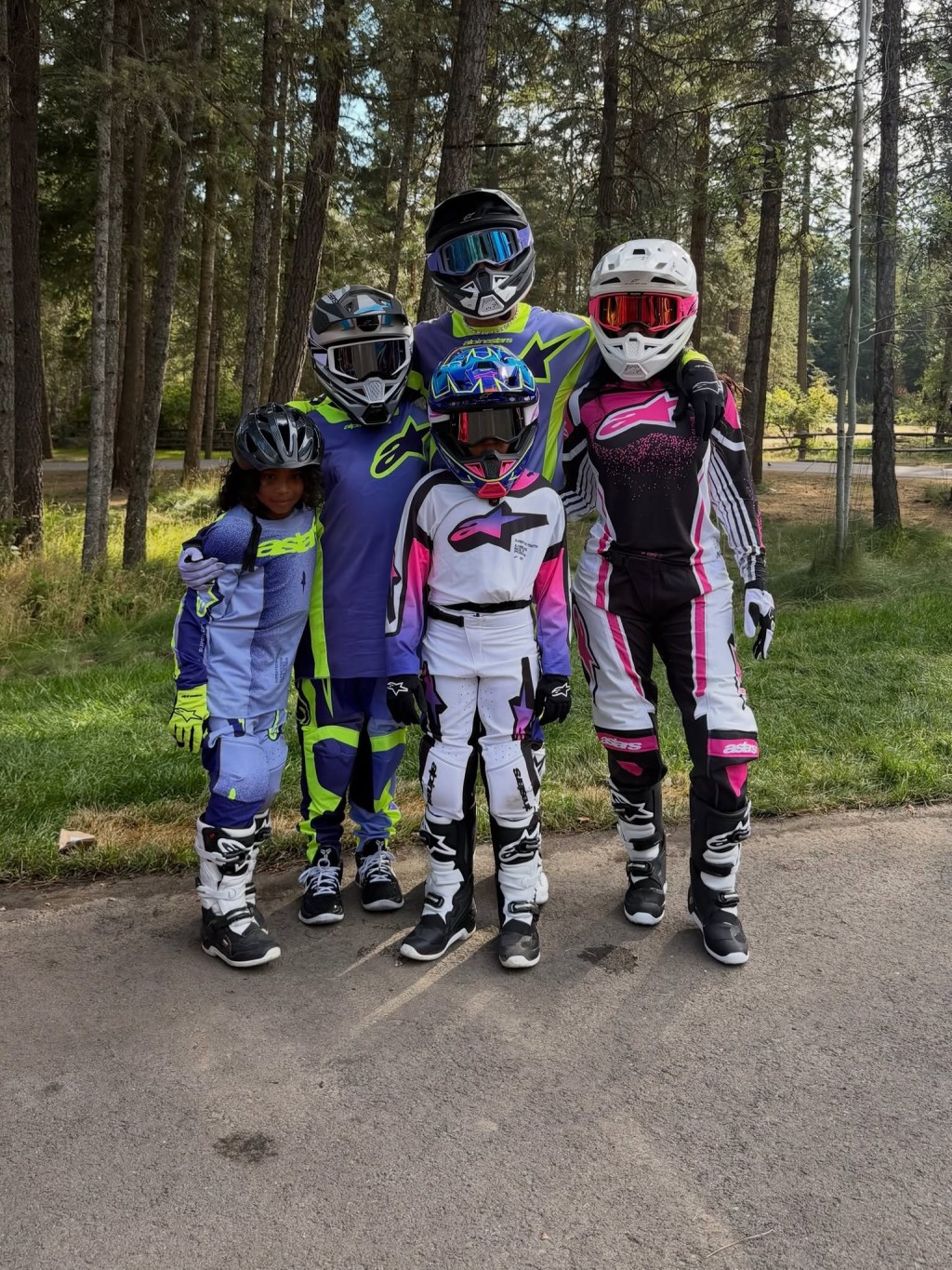 Five people, including Kim Kardashian and Lewis Hamilton, wearing motocross gear.