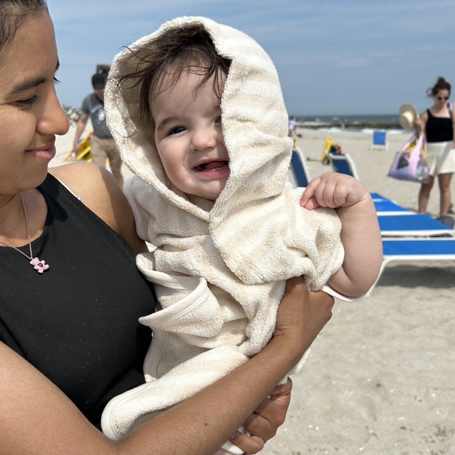 Warm and cozy for the baby, straight out of the water and into this Poncho towel (Courtesy Daniel Landesman Photography)