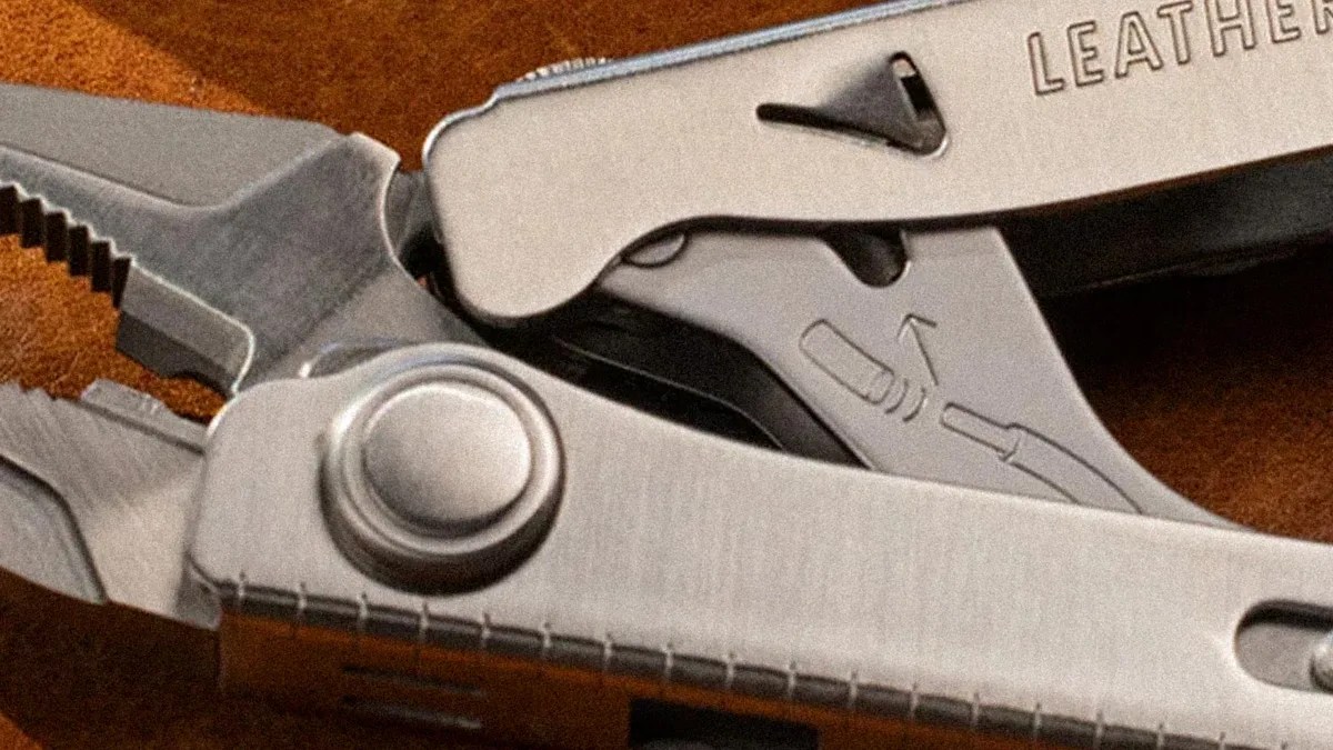 Close-up of a stainless steel multitool with pliers and a partially visible
