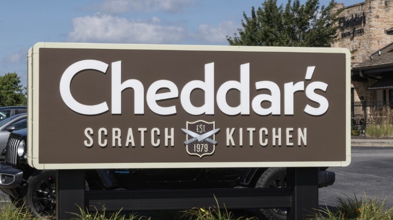 A sign for Cheddar's Scratch Kitchen seen from the parking lot.