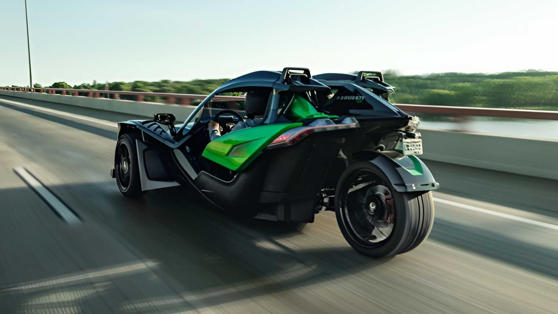Polaris Slingshot Grand Touring accelerating on a bridge rear third quarter view