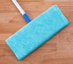 Microfiber mop head on a wooden floor with the caption,
