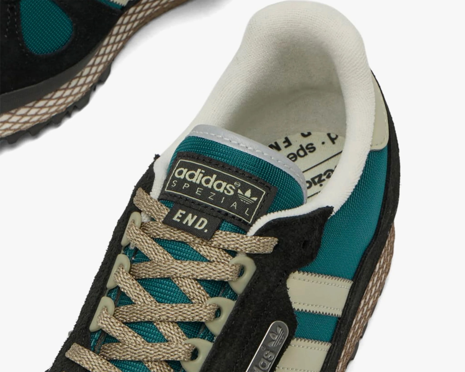 Close-up of teal and black Adidas Spezial sneaker with beige laces and END. label on tongue.