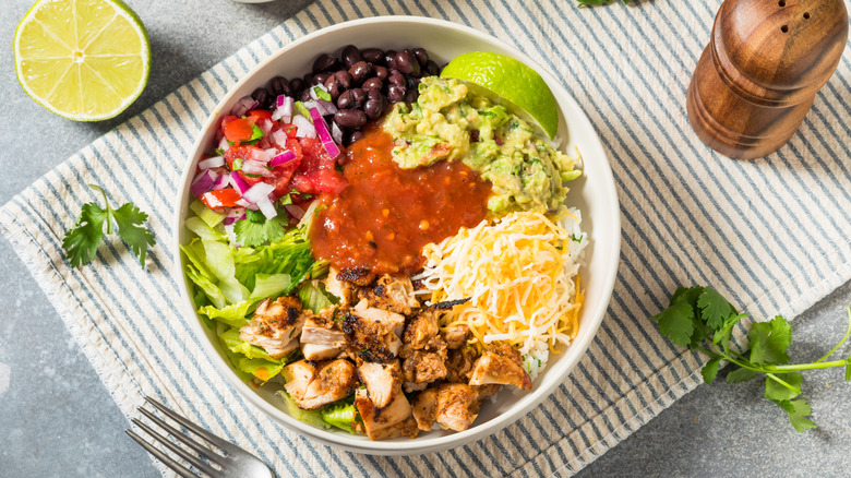Colorful homemade burrito bowl in white bowl