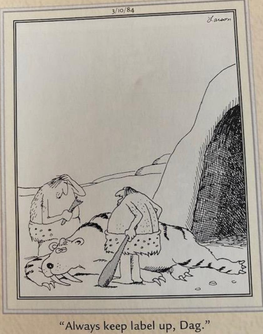 A caveman instructs another caveman about swinging a bat