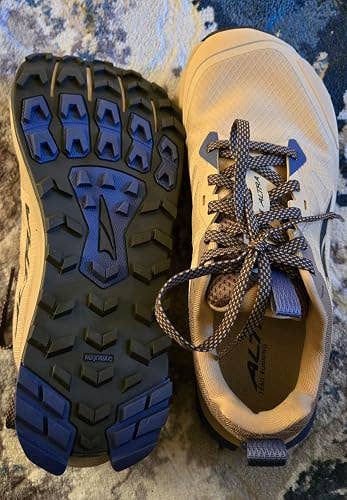 Trail running shoes with textured soles designed for grip on rough terrains