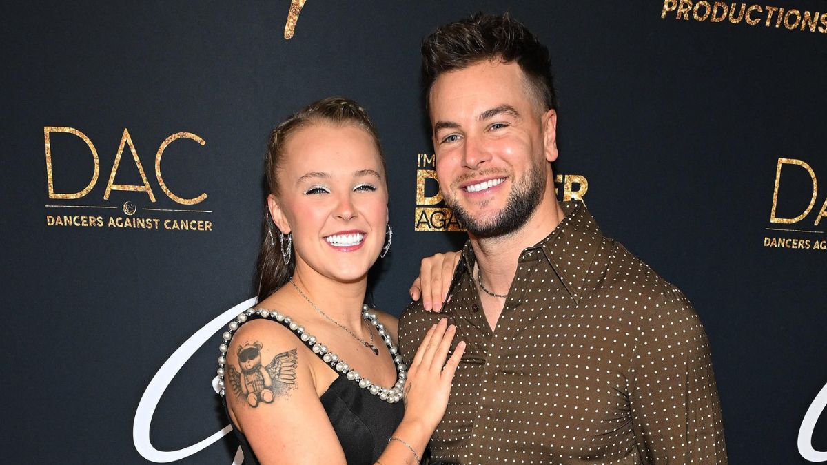 JoJo Siwa and Chris Hughes share passionate on-stage kiss in LA as he teases potential engagement