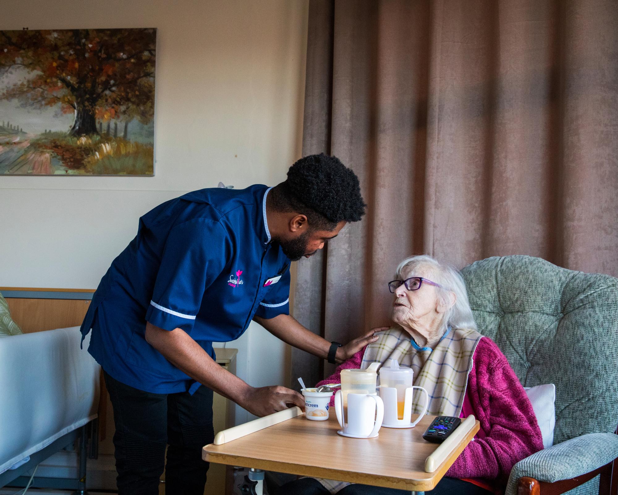 Ghanaian nurse Evans Sarbeng with resident Phyllis Padham at St Cecilia’s nursing home in Scarborough. Photograph: Gary Calton/The Observer