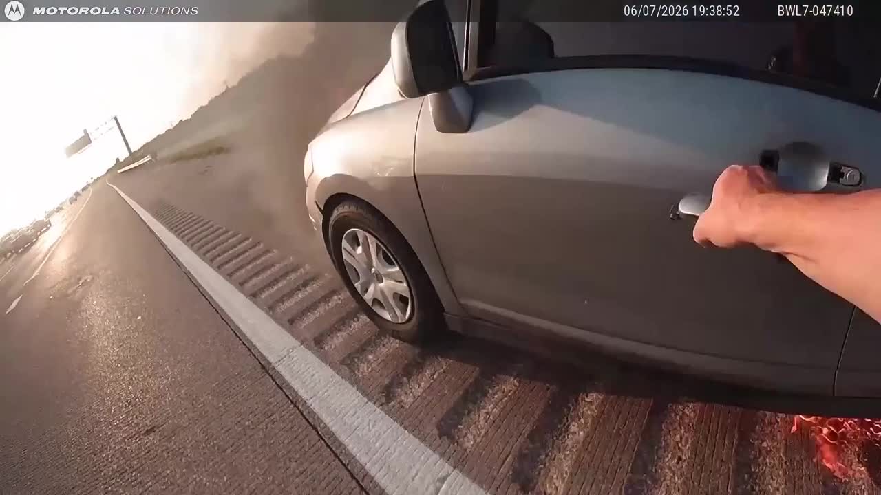 Dramatic moment police officer pulls driver from burning car before ...