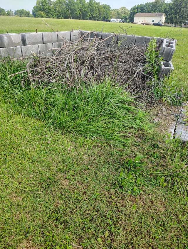 Community-garden compost bin is a giant pile of sticks, and composters ...