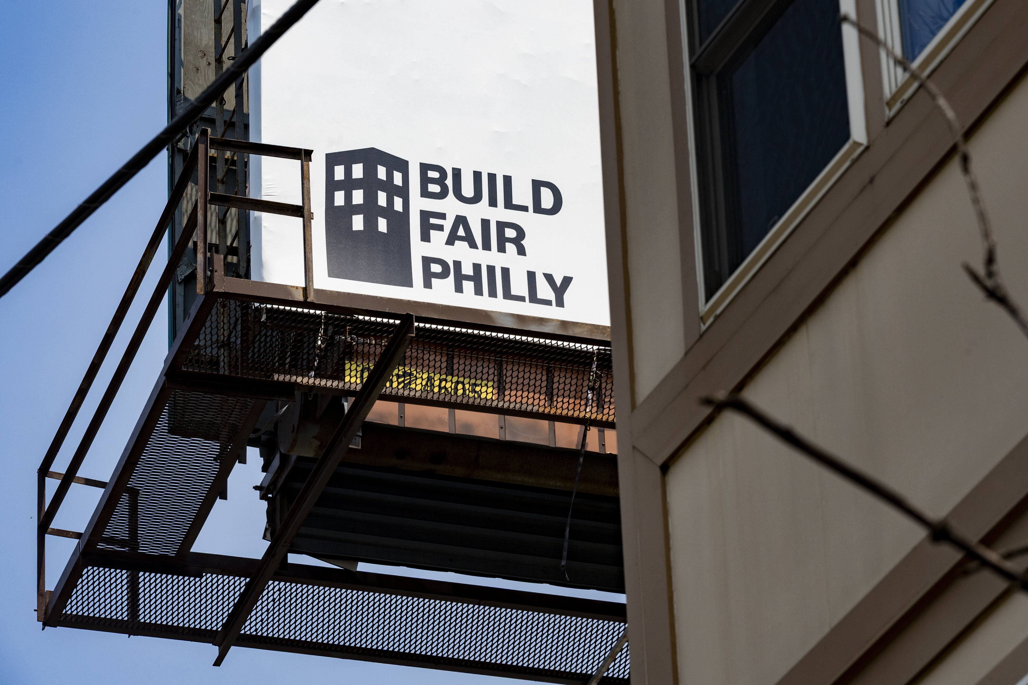Who's behind the orange signs around Philly criticizing rogue developers?