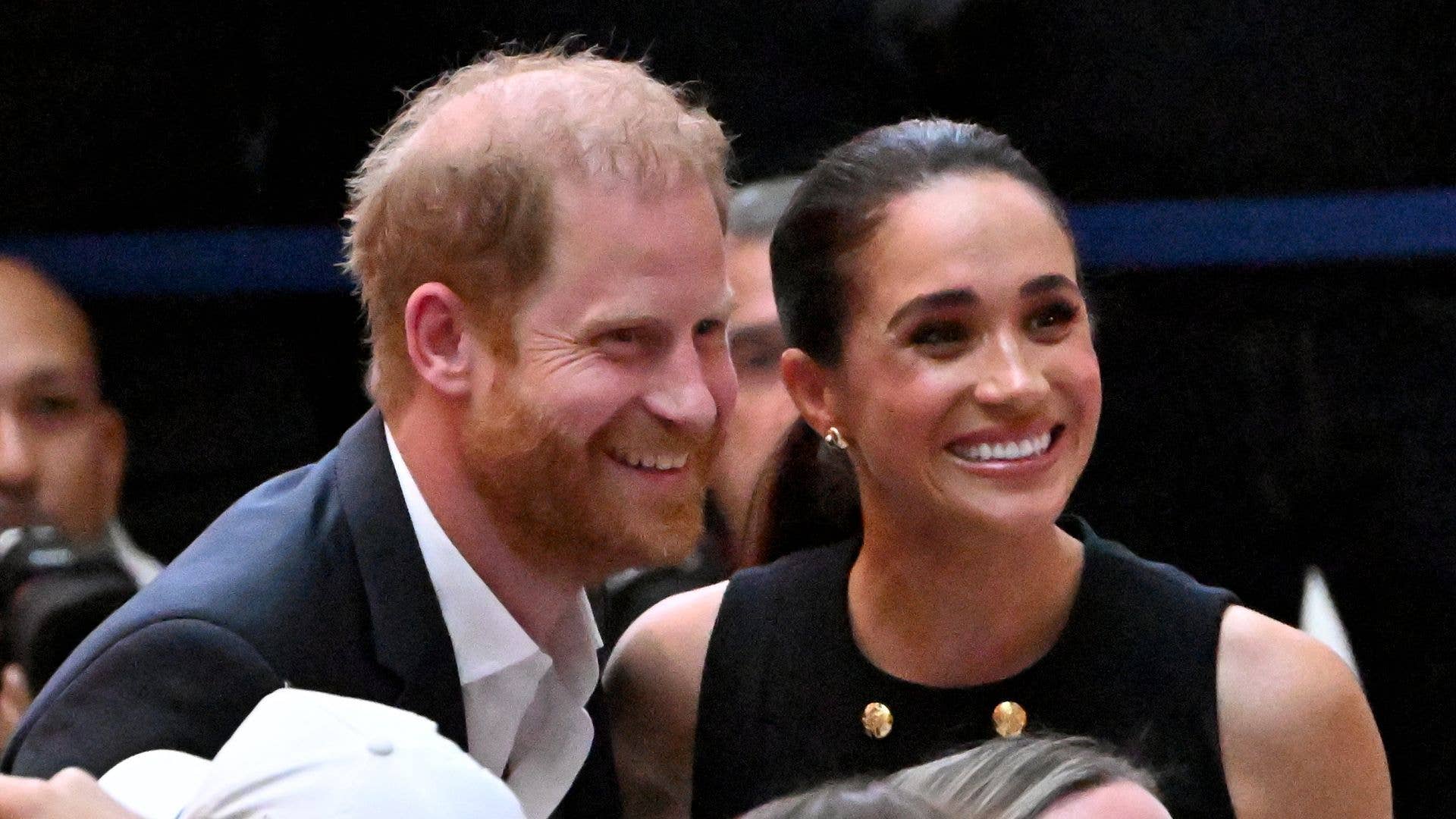 Britain's Prince Harry (L), Duke of Sussex, and his wife Meghan (R), the Duchess of Sussex, meet people at the Royal Children's Hospital in Melbourne on April 14, 2026. 