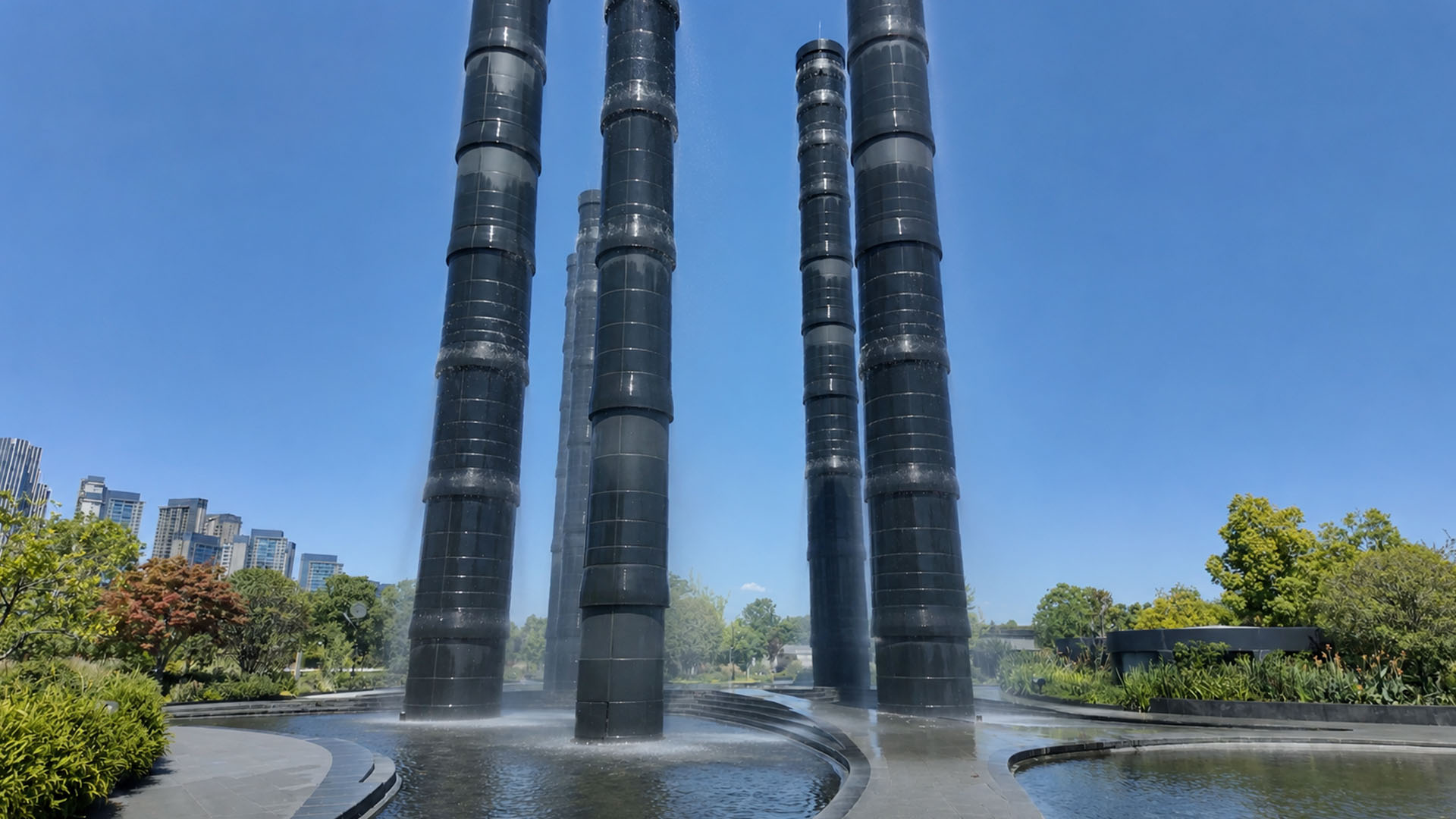 A futuristic water plaza hidden between towering black columns