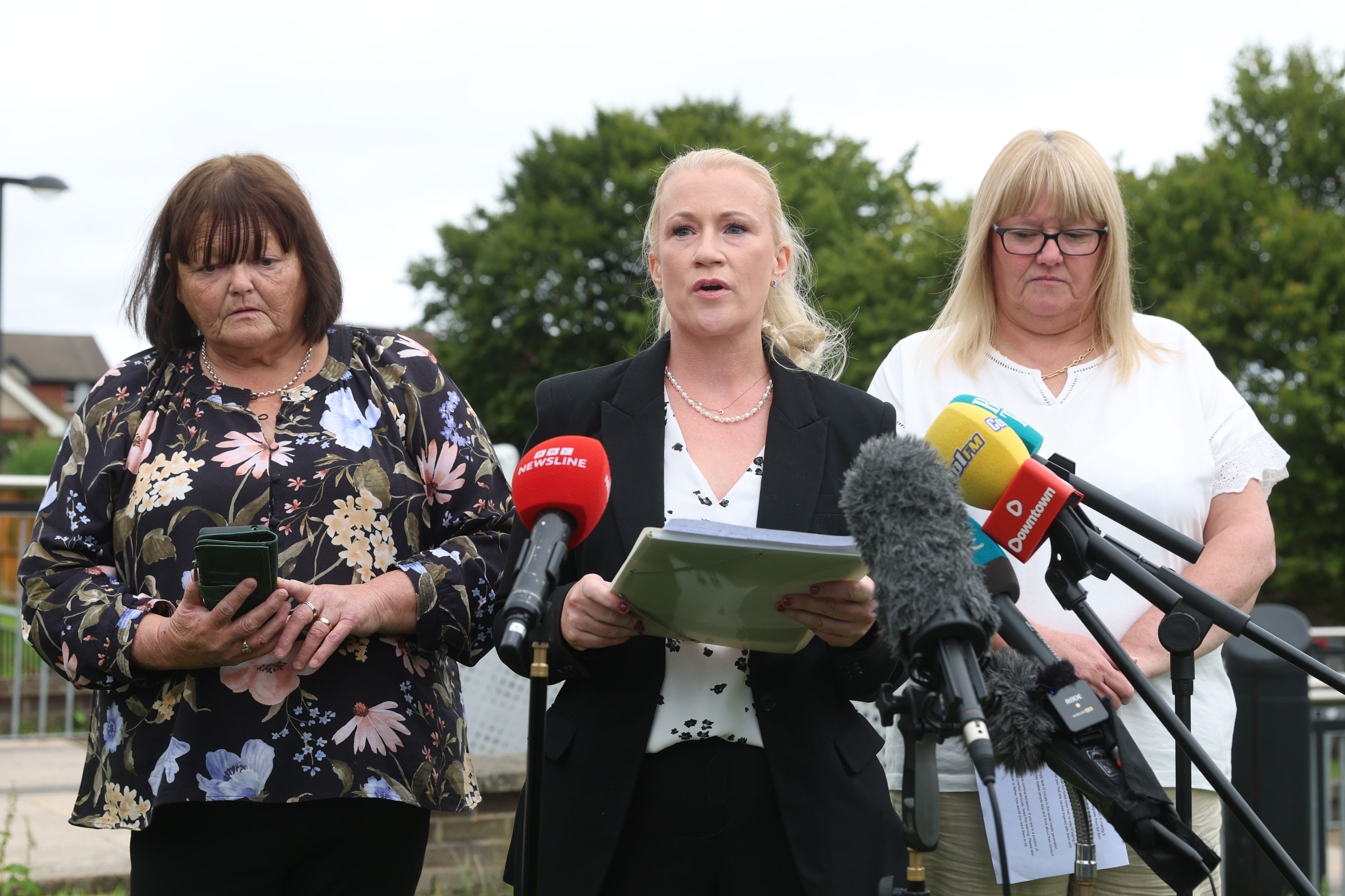 PSNI Detective Chief Inspector Claire McDonald (centre) with family members of affected patients, Tanya (right) and Shirley, outside Craigavon Crown Court (Liam McBurney/PA) (PA Wire)