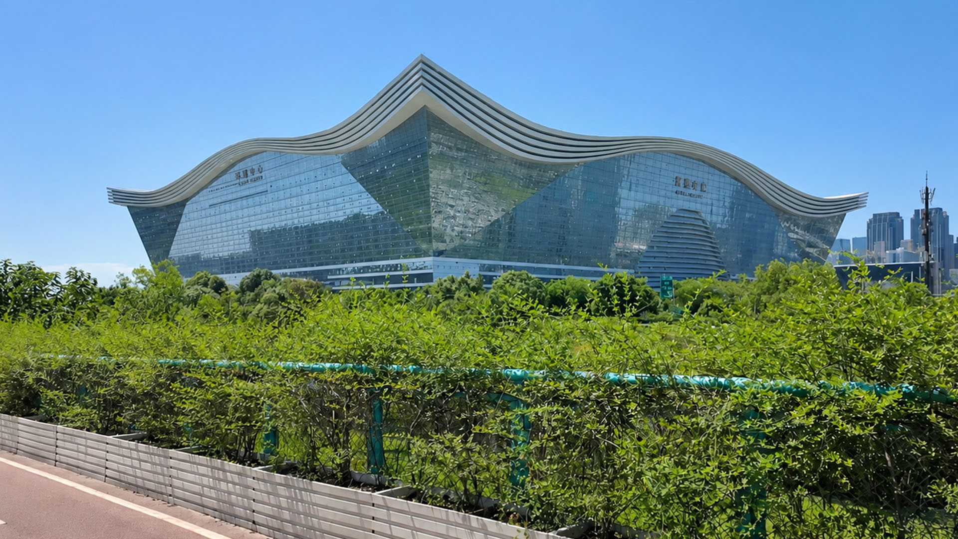 A giant curved roof gives this glass building a distinct identity