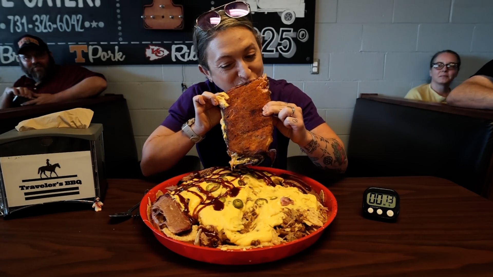 Woman attempts giant BBQ nacho challenge loaded with ribs and brisket