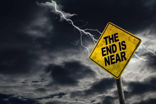 A yellow warning sign against a stormy sky with a lightning bolt in the background, displaying the text 