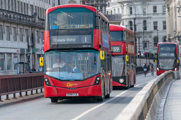 Driver of a Double Decker Red London Bus Route 1 driving during Coronavirus COVID-19 pandemic lockdown on Waterloo Bridge, London, England - 2
