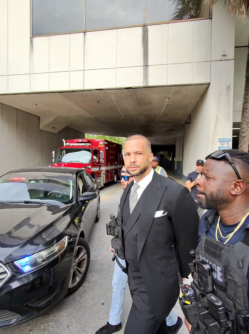 Tristan Tate (pictured) and Andrew are facing 59 total criminal charges in the UK. BACKGRID