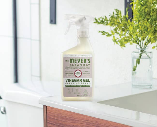 Meyer’s Vinegar Gel Cleaning Spray on a kitchen counter near a plant, with modern shelving in the background