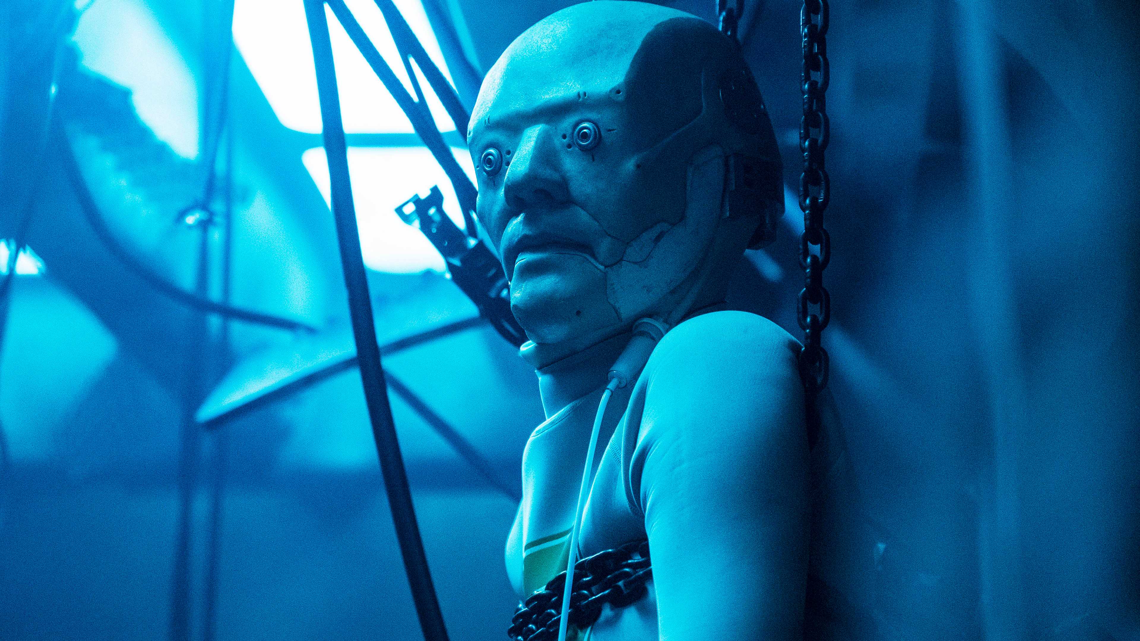 An android looking to the left with wires hanging around it in Raised by Wolves
