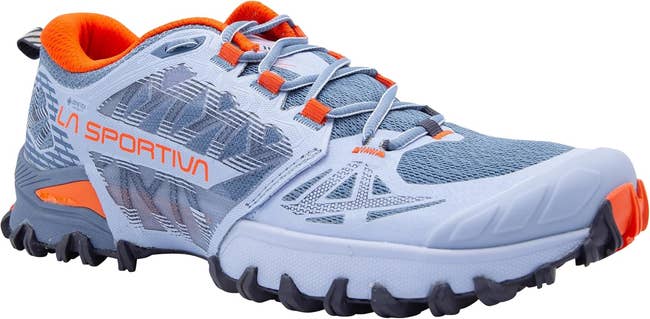 Trail running shoe with rugged sole and breathable mesh design, featuring contrasting laces and brand name. Suitable for outdoor activities