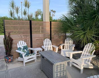 Outdoor patio with four Adirondack chairs and a coffee table, suitable for a garden setup
