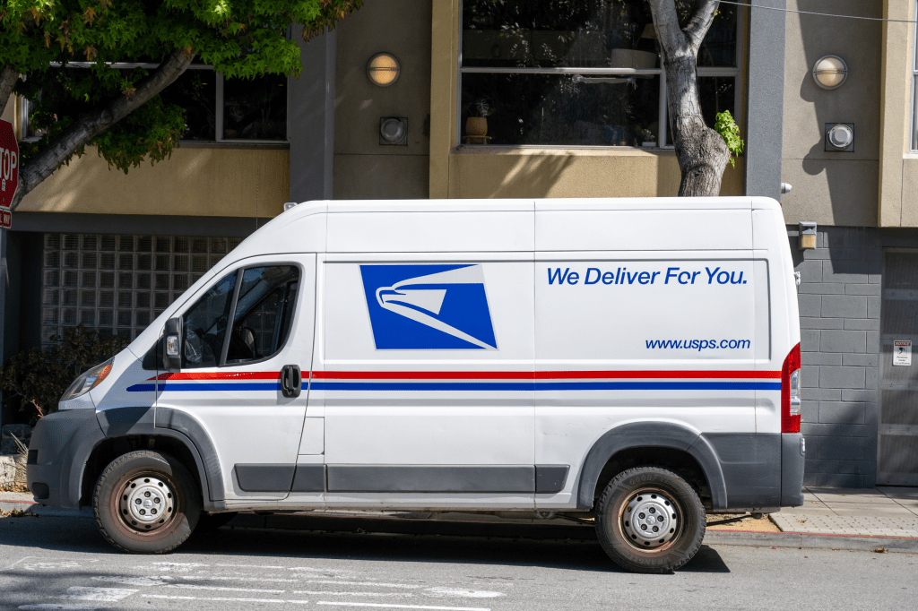 United States Postal Service delivery van parked on residential street in front of a building, San Francisco, California, April 28, 2026.
