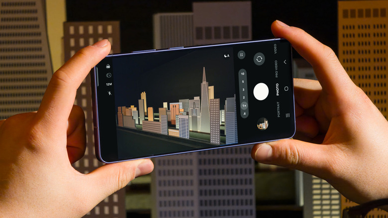 Person taking a photo using the Samsung Galaxy S26 Ultra phone.