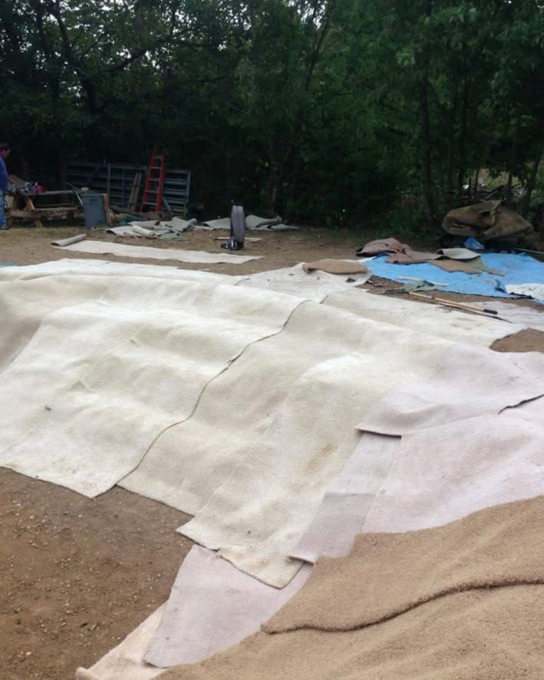 Construction site with materials such as fabric and equipment for a pond or pool feature under construction