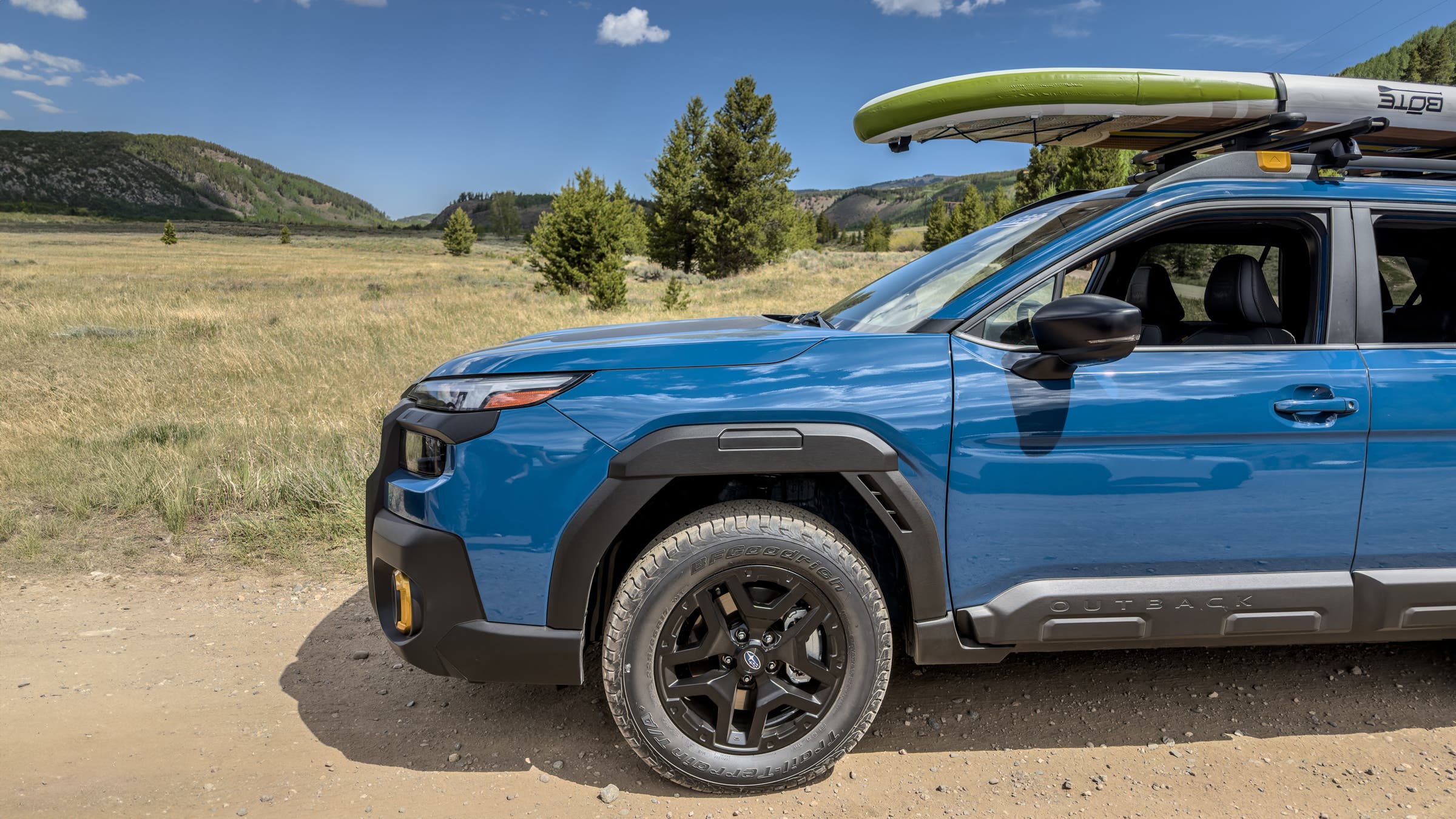 BF Goodrich Trail-Terrain T/A + off-road tire on Subaru Forrester driving on dirt road carrying cargo