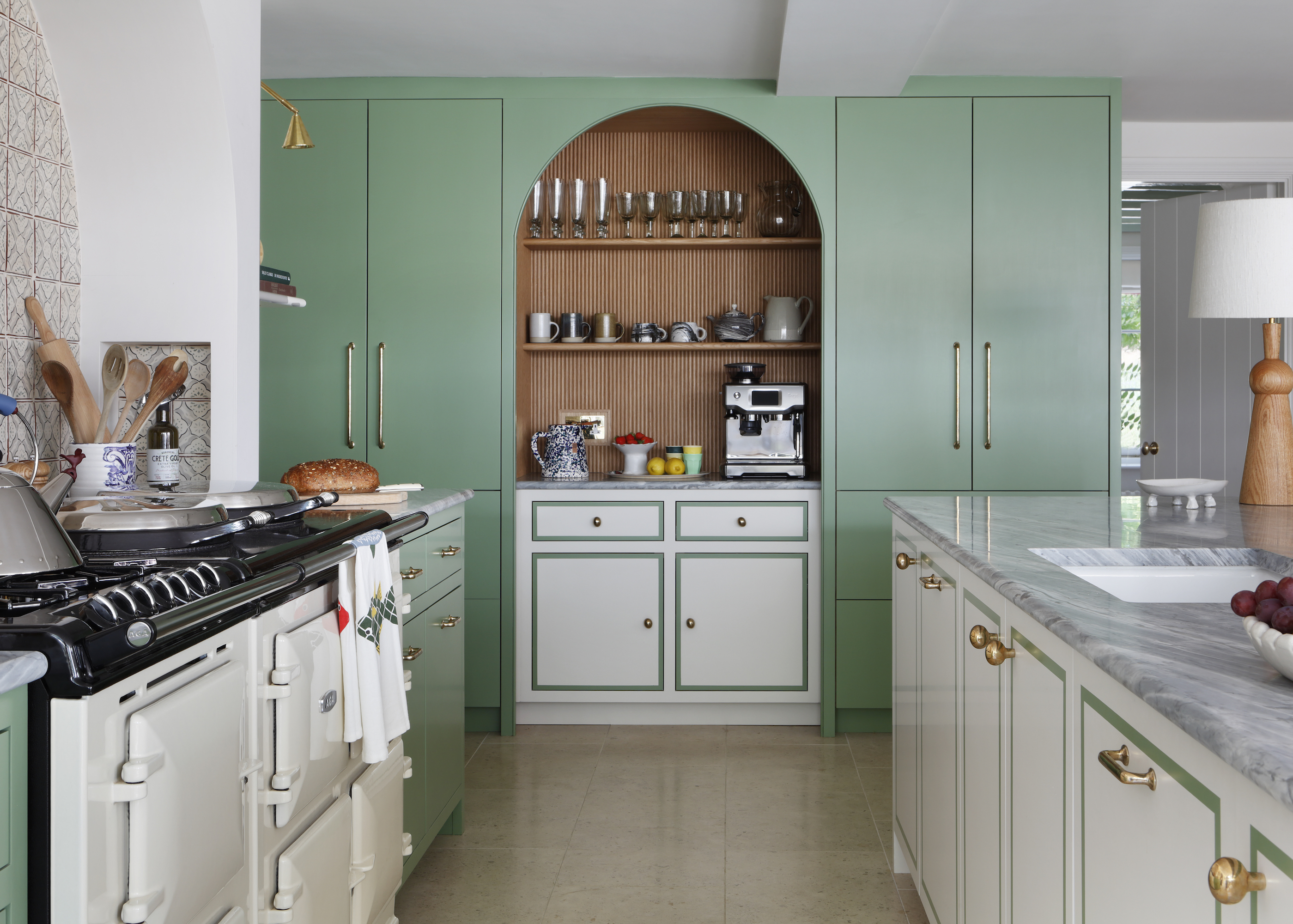 two tone kitchen in green and white with white aga and white doors with a green trim
