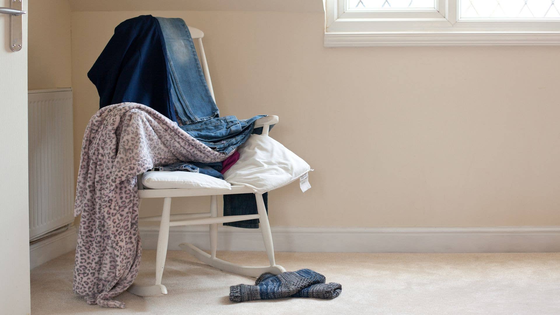 Bedroom chair loaded with clothes