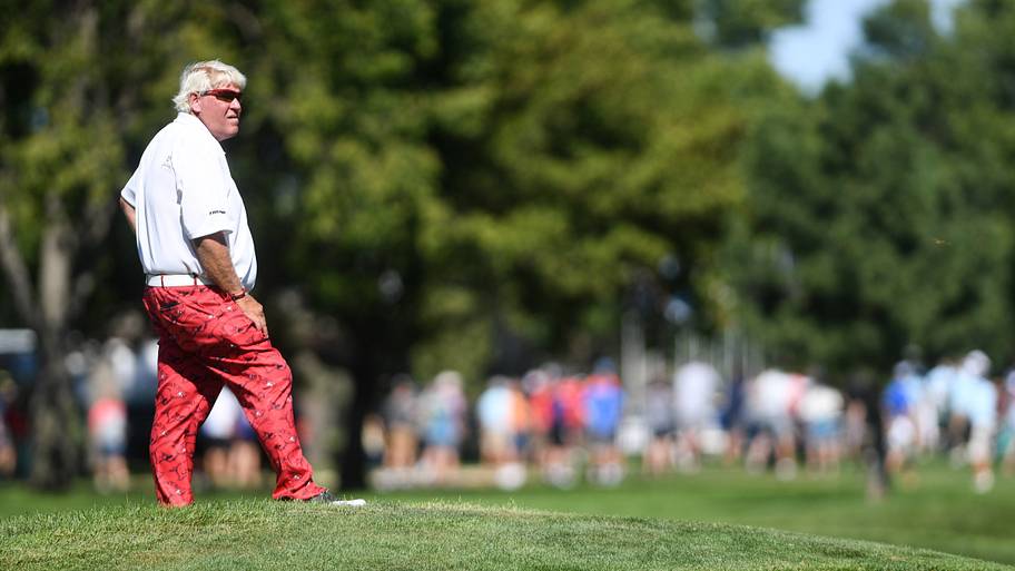 John Daly watches other golfers at the Sanford International