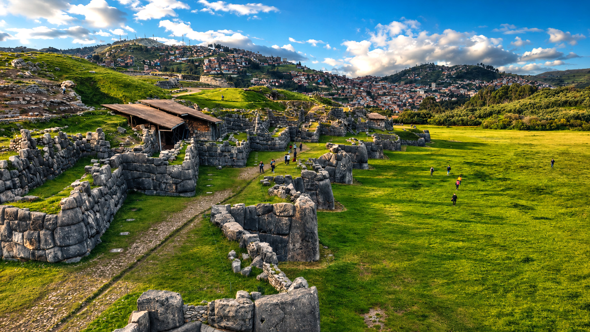 Ancient Inca walls still standing across Sacsayhuamán’s green fields