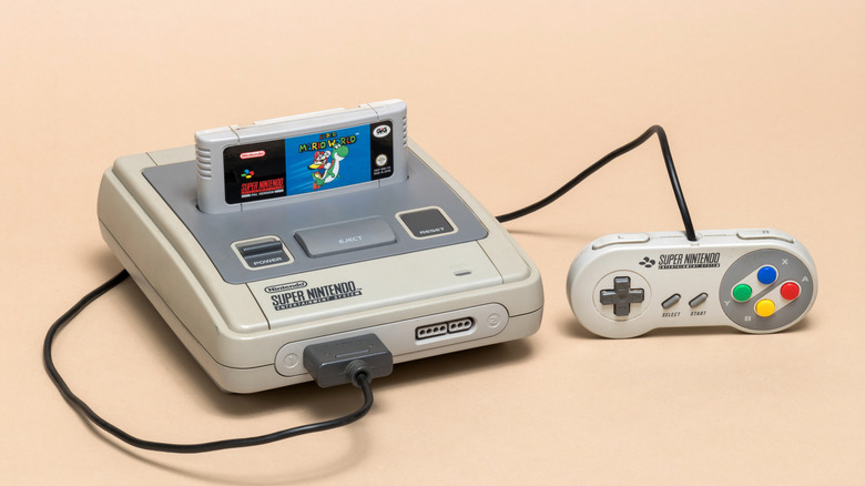 SNES with a Super Mario World cartridge inserted and a controller plugged in.