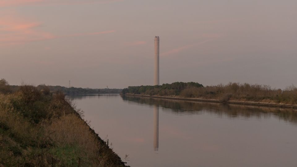 The Polesine Camerini power plant sits at the edge of the Po Delta, above a lagoon once rich in clams. Built in the 1980s, it promised economic growth but embedded heavy industry in a fragile ecosystem. Today, facing climate instability, the plant symbolizes an era when development came at the expense of ecological balance. - Chiara Negrello