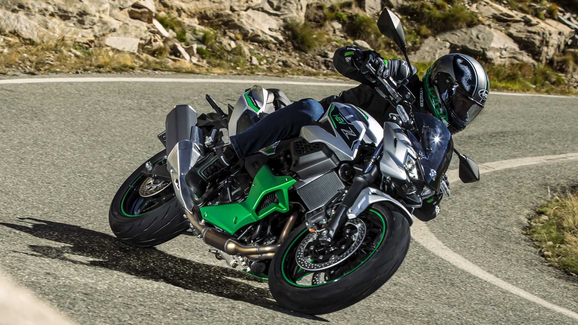 Kawasaki Z7 Hybrid cornering along a winding mountain road front third quarter cinematic shot