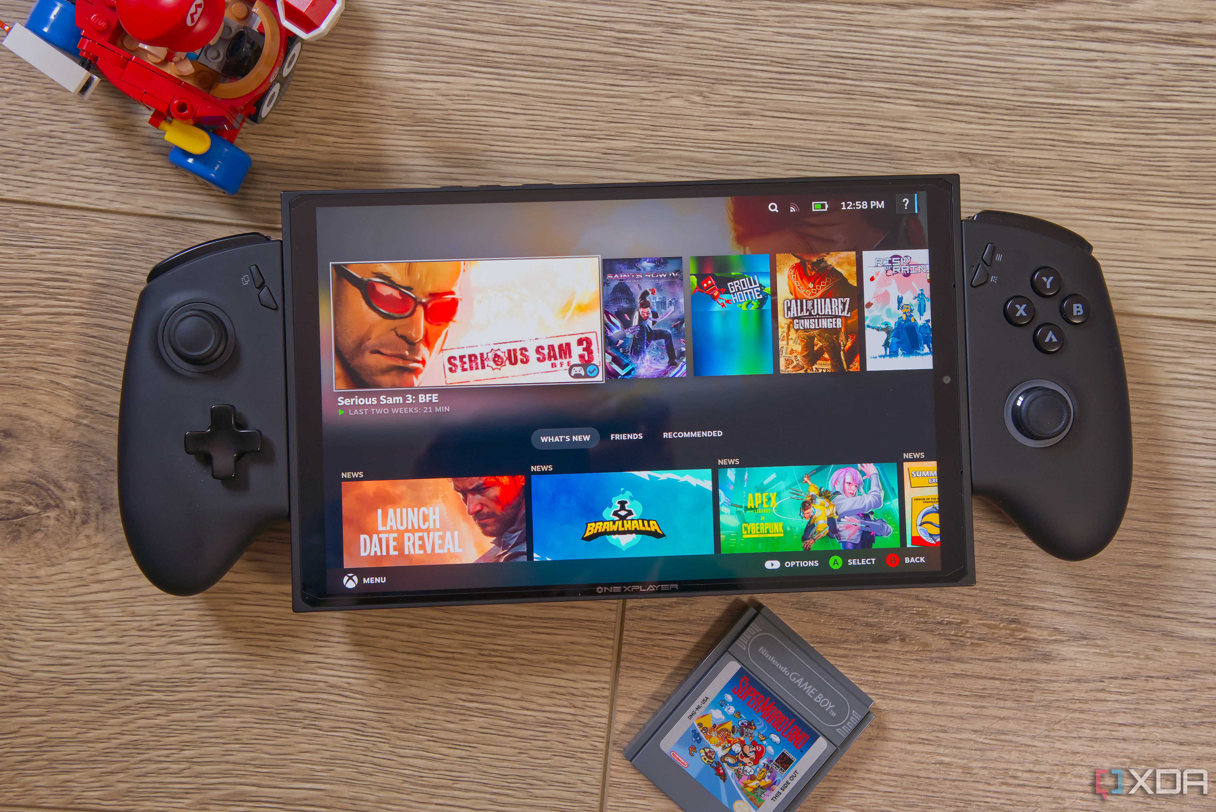 A gaming handheld showing the home page in Steam's gaming mode with games including Serious Sam 3, Saints Row IV Re-Elected, Grow Home, and Call of Juarez: Gunslinger