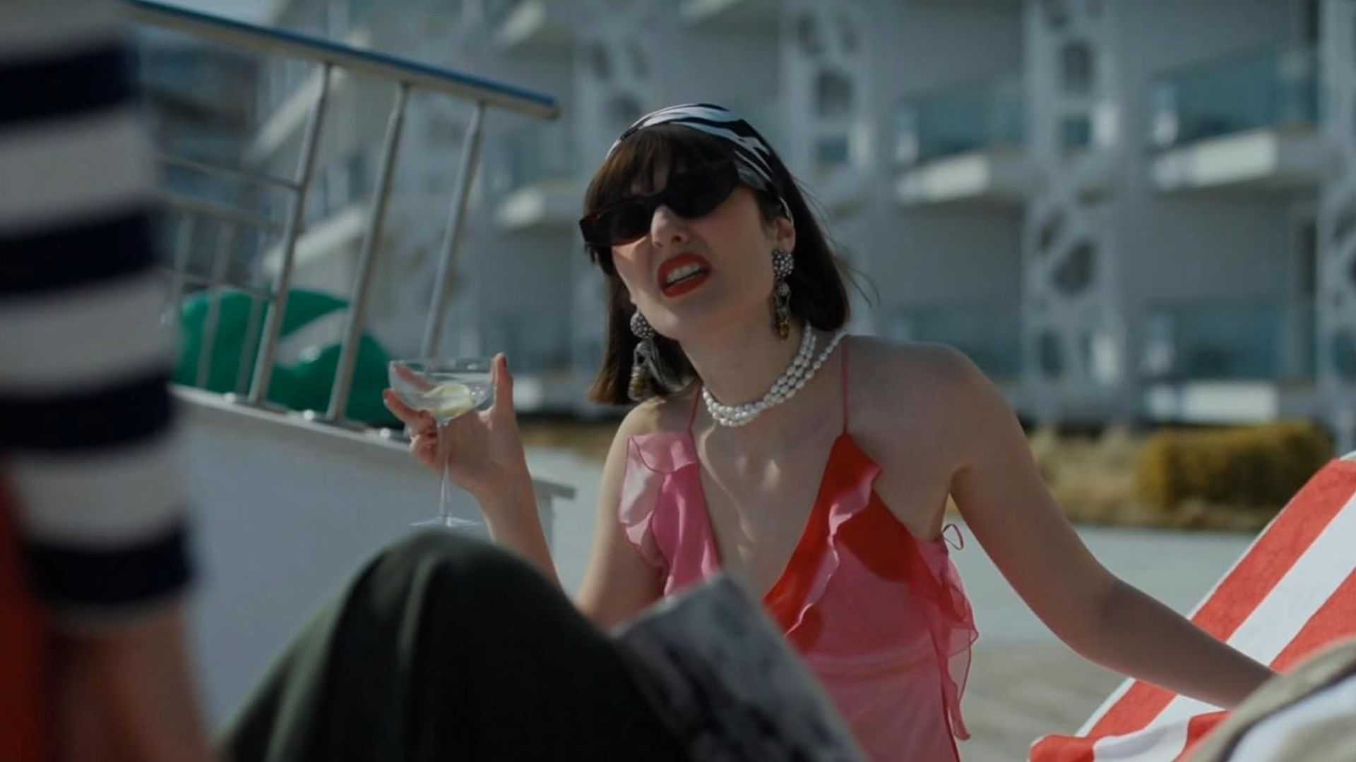 Isla sitting by pool in The Paradise Murders