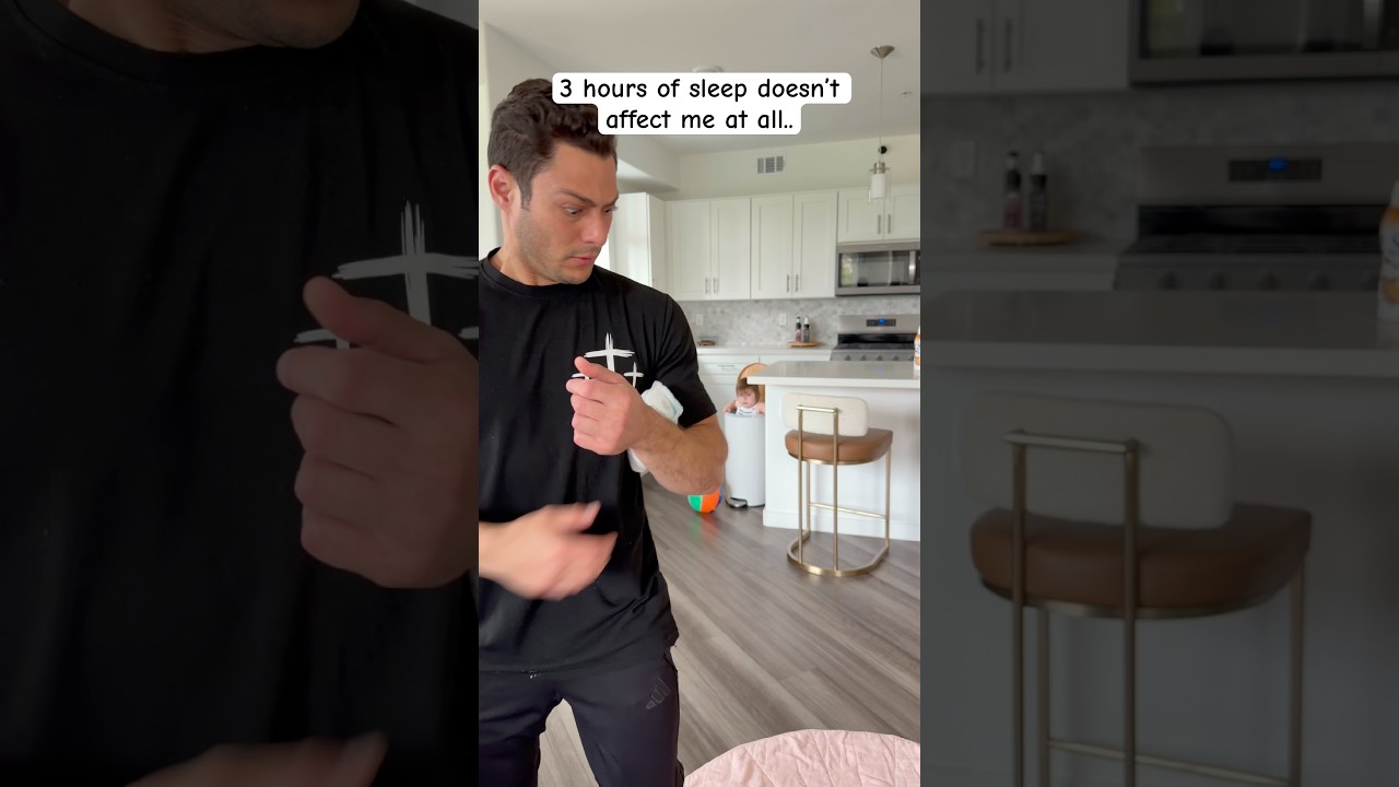 Tired dad struggles to stay awake with his newborn baby