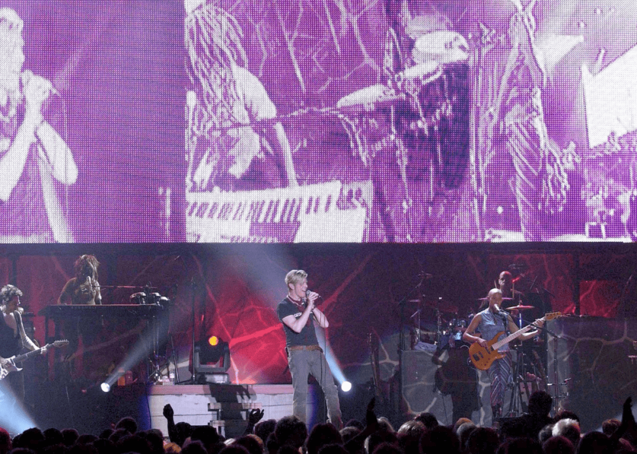 Bowie performs on stage.
