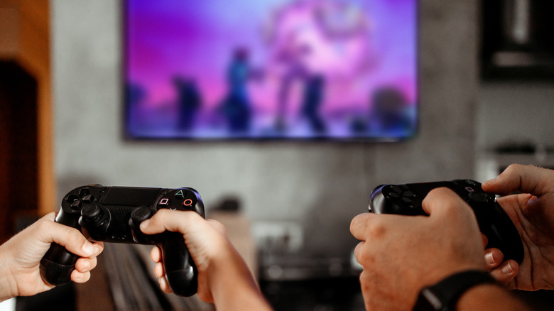 Two people playing a console video game together