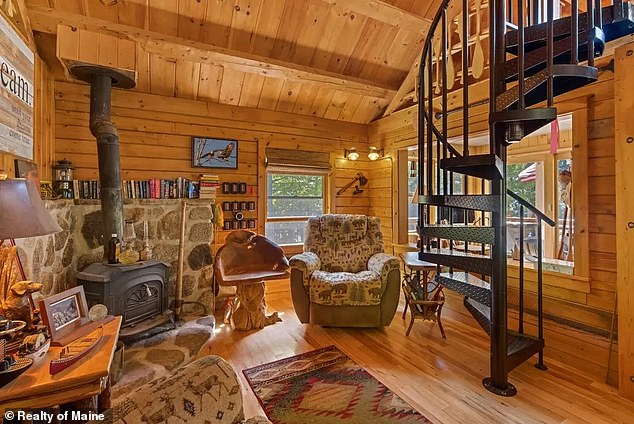 The lakeside property includes an all-wood interior with hickory floors and cabinetry, as well as a metal spiral staircase